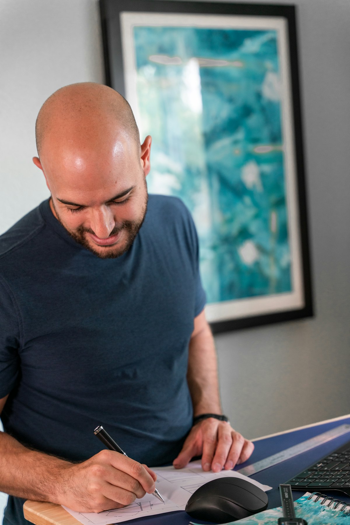 A man working something out on paper at a desk